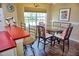 Cozy dining room area with round table, seating for four, large window, and nautical decor at 2077 Wetland Pt # 1103, Lutz, FL 33558