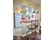 Bright kitchen with red countertops, white cabinetry, breakfast bar, and nautical decor at 2077 Wetland Pt # 1103, Lutz, FL 33558
