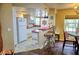 Bright kitchen with red countertops, white cabinetry, breakfast bar, and nautical decor at 2077 Wetland Pt # 1103, Lutz, FL 33558