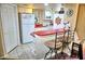 Bright kitchen with red countertops, white cabinetry, breakfast bar, and nautical decor at 2077 Wetland Pt # 1103, Lutz, FL 33558