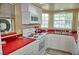 Charming kitchen featuring white cabinets, red counter tops, white appliances and natural lighting at 2077 Wetland Pt # 1103, Lutz, FL 33558