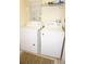 Convenient laundry room includes a washer and dryer for easy chores at 2077 Wetland Pt # 1103, Lutz, FL 33558