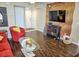 Well lit living room featuring a mounted television, unique furniture and dark floors at 2077 Wetland Pt # 1103, Lutz, FL 33558