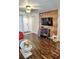Living room featuring a mounted television, unique furniture and dark floors at 2077 Wetland Pt # 1103, Lutz, FL 33558