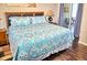 Comfortable main bedroom with queen bed, wood headboard, and access to the balcony at 2077 Wetland Pt # 1103, Lutz, FL 33558