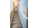 Elegant carpeted staircase with wooden railings and wall sconces at 9943 Milano Dr, Trinity, FL 34655