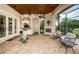 Outdoor kitchen and patio area with fireplace and seating at 9943 Milano Dr, Trinity, FL 34655