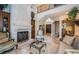 Living room boasts a large stone fireplace and comfortable seating at 9943 Milano Dr, Trinity, FL 34655