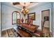 Formal dining room with a large wooden table and chandelier at 9943 Milano Dr, Trinity, FL 34655