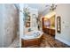Elegant bathroom with soaking tub, double vanity, and marble flooring at 9943 Milano Dr, Trinity, FL 34655