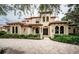 Two-story house with a tile roof and landscaped front yard at 9943 Milano Dr, Trinity, FL 34655