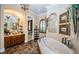 Luxurious bathroom with soaking tub, double vanity, and walk-in shower at 9943 Milano Dr, Trinity, FL 34655