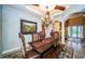 Bright dining room featuring a rustic wooden table and elegant chairs at 9943 Milano Dr, Trinity, FL 34655