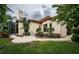 Landscaped backyard with paved walkway and lush greenery at 9943 Milano Dr, Trinity, FL 34655