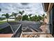 Private balcony overlooking a screened-in pool and spa with lake views at 9943 Milano Dr, Trinity, FL 34655