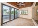 Bright sunroom with tiled floors, sliding glass doors, and lake views at 9943 Milano Dr, Trinity, FL 34655