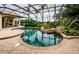 Inviting pool and spa area with screened enclosure at 9943 Milano Dr, Trinity, FL 34655