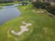 Aerial view of a lush green golf course with water features at 9943 Milano Dr, Trinity, FL 34655