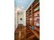 Hallway with built-in bookcases and hardwood floors at 9943 Milano Dr, Trinity, FL 34655