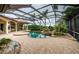 Expansive pool and spa with screened enclosure, outdoor kitchen, and lush landscaping at 9943 Milano Dr, Trinity, FL 34655