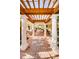 Outdoor pergola with seating area, creating a shaded and relaxing space at 9943 Milano Dr, Trinity, FL 34655