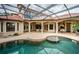 Resort-style pool with covered patio, outdoor kitchen, and ample seating at 9943 Milano Dr, Trinity, FL 34655