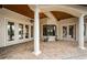 Covered patio with brick flooring, elegant columns, and French doors leading inside at 9943 Milano Dr, Trinity, FL 34655