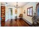 Elegant sitting room featuring hardwood floors, built-in shelves, and a chandelier at 9943 Milano Dr, Trinity, FL 34655