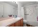 Bathroom with tub shower, vanity, and floral tile at 4336 Lightfoot St, Spring Hill, FL 34609