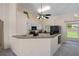 Kitchen with white cabinets, black appliances, and a breakfast bar at 4336 Lightfoot St, Spring Hill, FL 34609