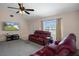 Living room with red reclining sofas, a large TV, and a view of the front yard at 4336 Lightfoot St, Spring Hill, FL 34609