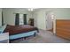 Spacious main bedroom with a large bed, dresser, and access to the bathroom at 4336 Lightfoot St, Spring Hill, FL 34609