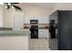 Kitchen boasts white cabinets, black appliances, and ample counter space at 4336 Lightfoot St, Spring Hill, FL 34609