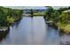 Tranquil waterfront view with neighboring homes and lush greenery at 3178 Sea Grape Dr, Hernando Beach, FL 34607