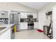 Kitchen with stainless steel appliances, granite countertops, and white cabinets at 10432 Monarch St, Spring Hill, FL 34608