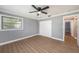 Bright bedroom with grey walls, wood-look floors, and ample closet space at 6989 300Th N Ave, Clearwater, FL 33761