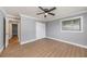 Well-lit bedroom with grey walls, wood-look floors and double closets at 6989 300Th N Ave, Clearwater, FL 33761