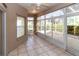 Sunroom with tiled floor and access to backyard at 2529 Sandy Hill Ct, Holiday, FL 34691