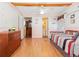 Bedroom with wood floors, twin bed, and access to bathroom at 9140 & 9130 Peony St, New Port Richey, FL 34654