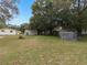 Spacious backyard with sheds and trees at 9140 & 9130 Peony St, New Port Richey, FL 34654