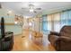 Living room with brown recliner and wooden floors at 9140 & 9130 Peony St, New Port Richey, FL 34654
