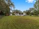 View of home's back and side yard with shed at 9140 & 9130 Peony St, New Port Richey, FL 34654