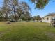 Spacious backyard with mature trees and a utility vehicle at 9140 & 9130 Peony St, New Port Richey, FL 34654