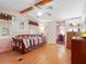 Bedroom with wood floors, twin bed, and built-in dresser at 9140 & 9130 Peony St, New Port Richey, FL 34654