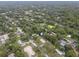 An aerial view of a home in a neighborhood, close to a canal at 9140 & 9130 Peony St, New Port Richey, FL 34654