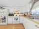 White kitchen with wood flooring and stainless steel sink at 9140 & 9130 Peony St, New Port Richey, FL 34654