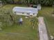 Aerial view of a house with a yard and shed at 9140 & 9130 Peony St, New Port Richey, FL 34654