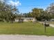 House exterior with a mailbox and large yard at 9140 & 9130 Peony St, New Port Richey, FL 34654