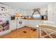 Bright kitchen with white cabinets, wood floors, and a breakfast bar at 9140 & 9130 Peony St, New Port Richey, FL 34654