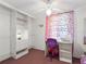 Well-lit bedroom with built-in shelving and desk at 9140 & 9130 Peony St, New Port Richey, FL 34654